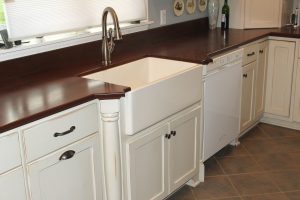 farm sink in antique white cabinetry